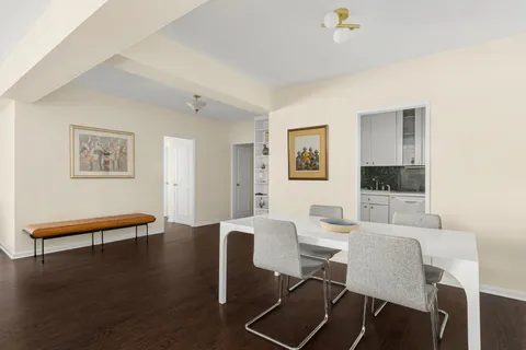 a dining room with furniture and wooden floor