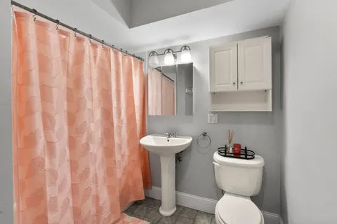 a bathroom with a sink toilet and a shower