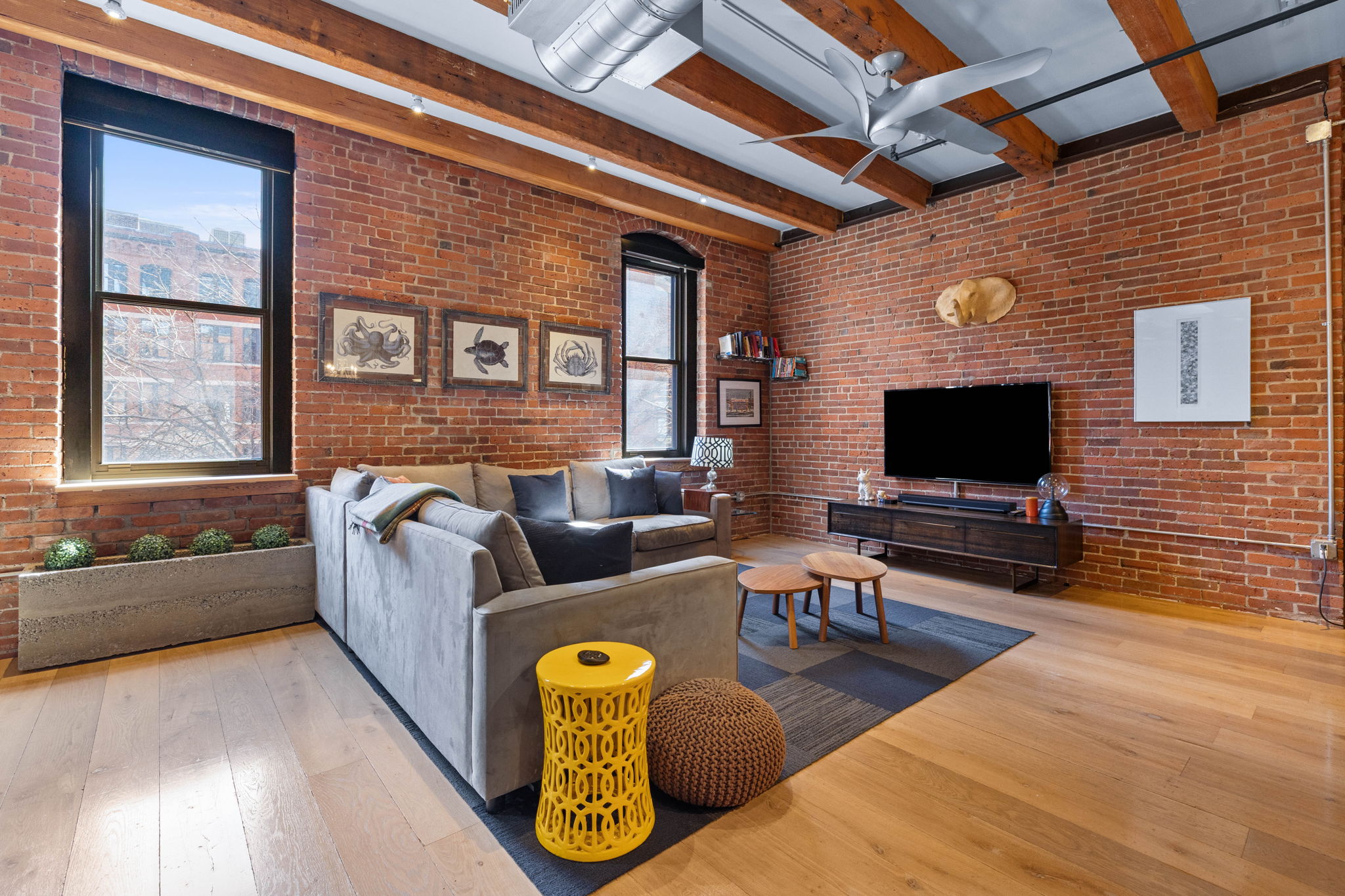 33 Sleeper Street, Unit 307 Boston, MA 02210 - Photo 8 of 15 a living room with furniture and a flat screen tv