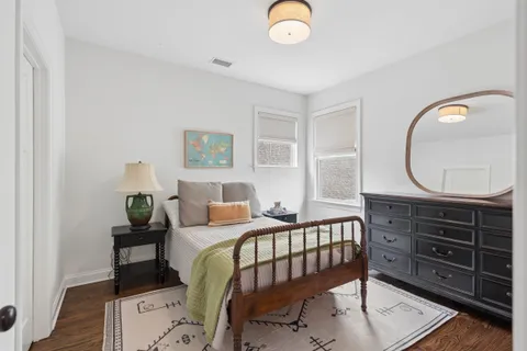 a bedroom with a bed and a dresser