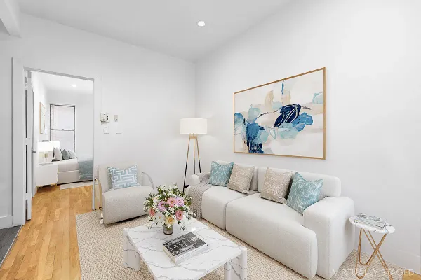 a living room with furniture and a painting