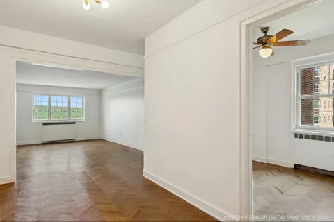 an empty room with windows and closet