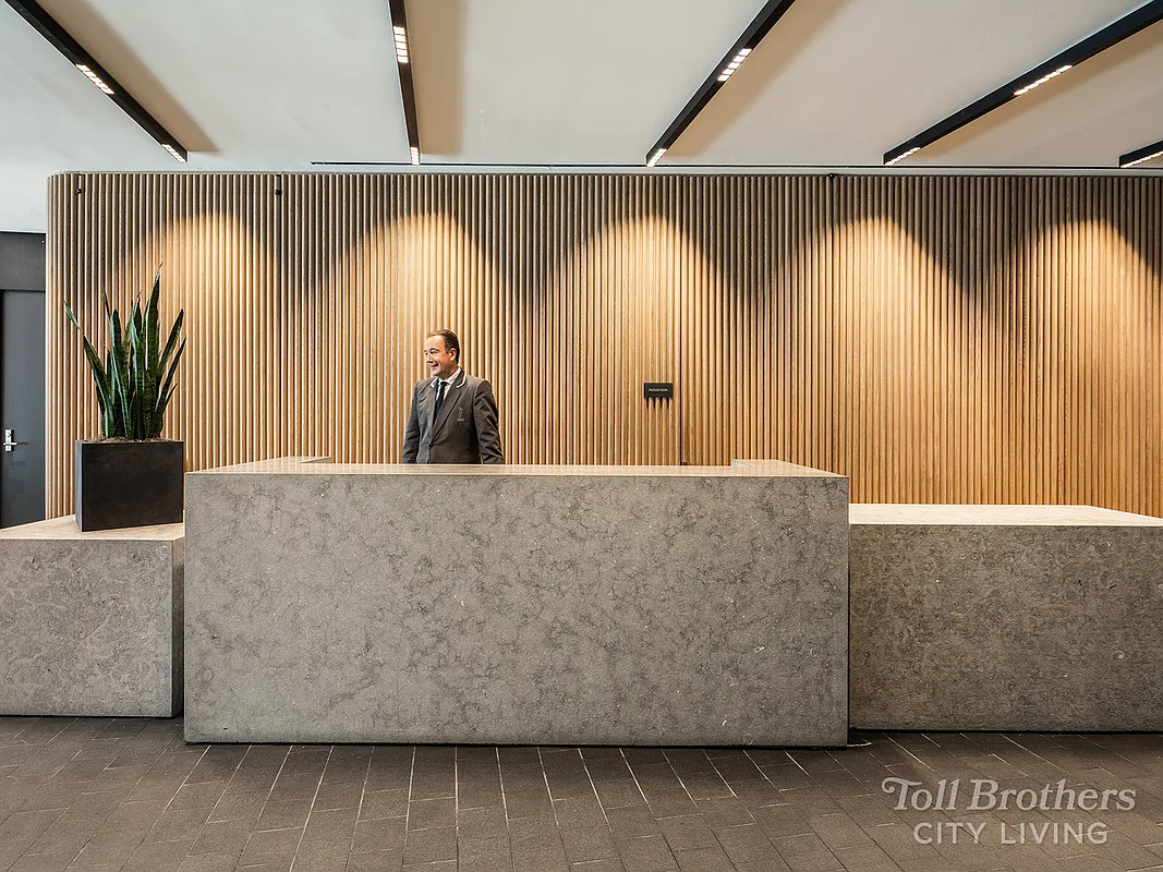 77 Charlton Street, Unit N7D Manhattan, NY 10014 - Photo 10 of 14 a living room with a couch and a table