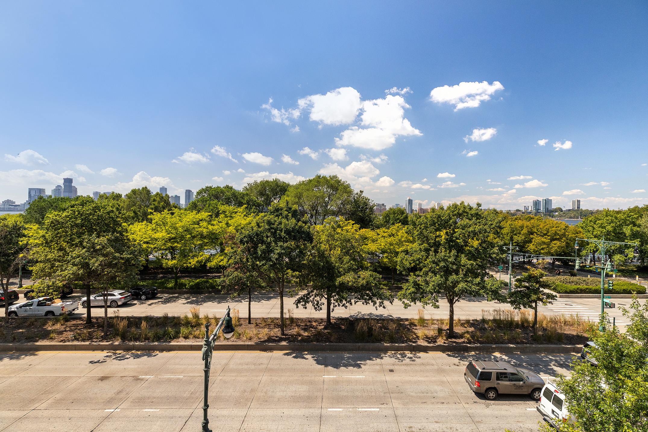 167 Perry Street, Unit 4NQ Manhattan, NY 10014 - Photo 16 of 20 a street view with residential building and trees around