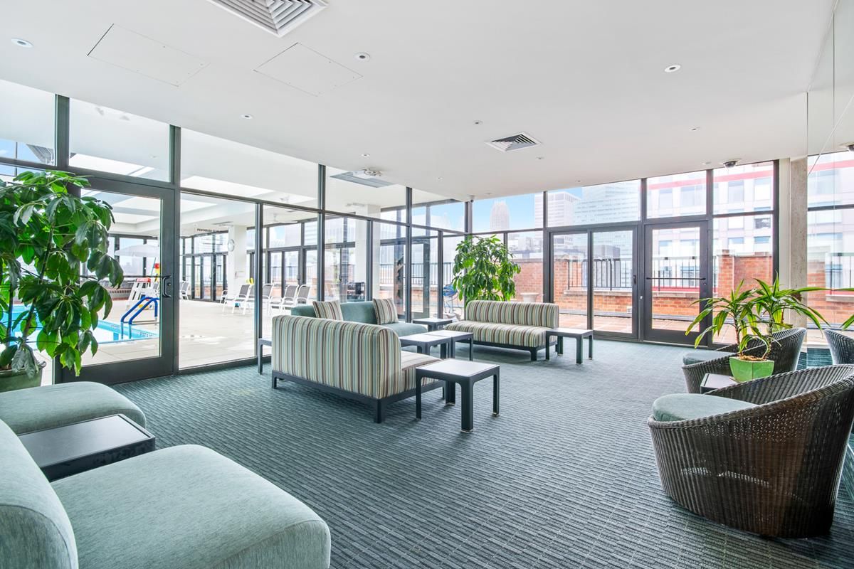 300 East 54th Street, Unit 15C Manhattan, NY 10022 - Photo 9 of 10 a living room with furniture and a large window