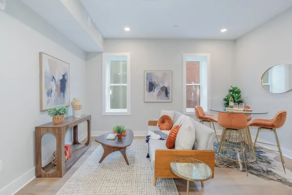 a living room with furniture a rug and a large window