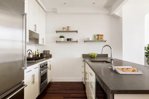 a kitchen with stainless steel appliances a stove a sink and a refrigerator