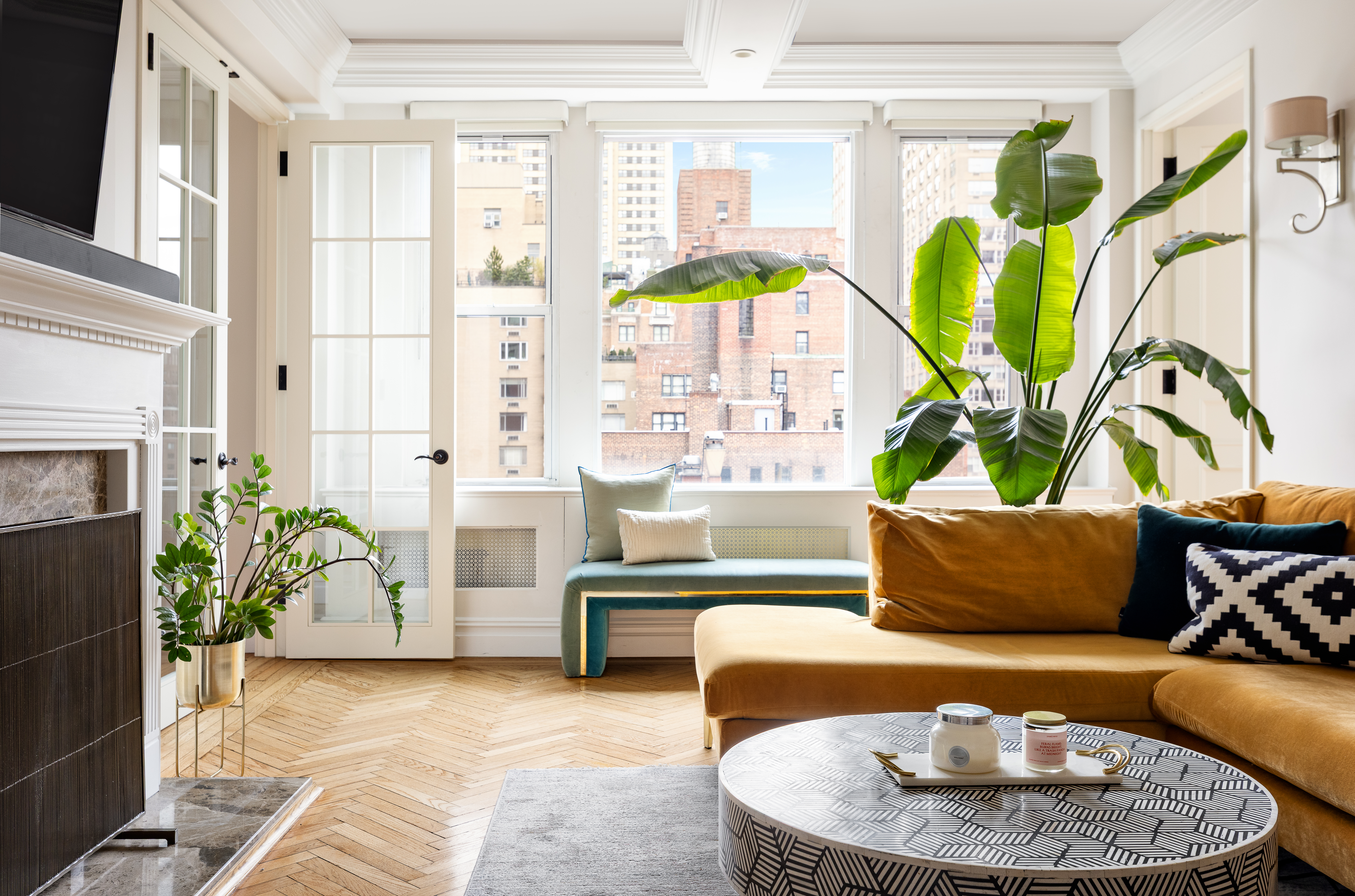 55 Park Avenue, Unit 9E Manhattan, NY 10016 - Photo 2 of 9 a living room with furniture and a potted plant