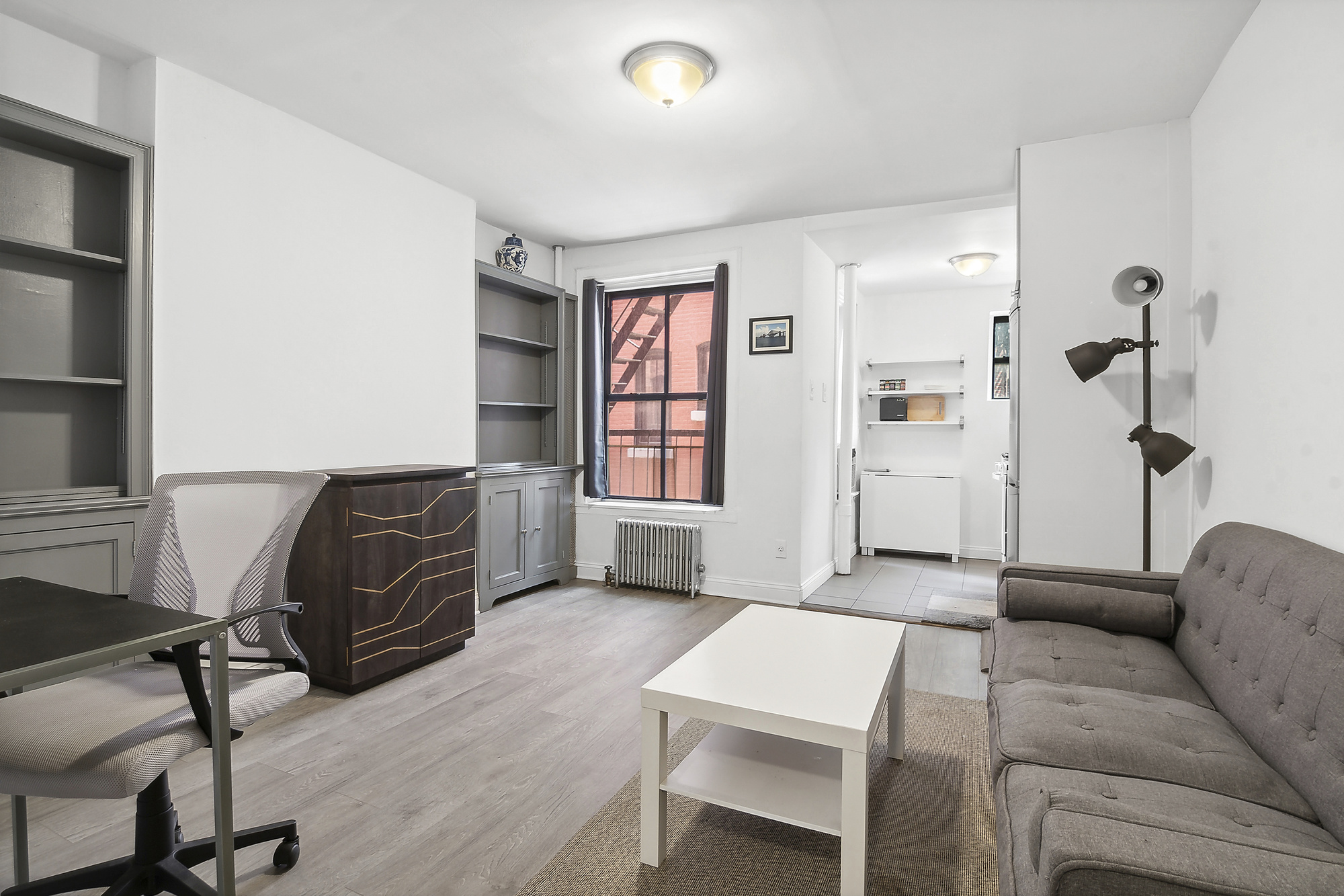 439 Hicks Street, Unit 2C Brooklyn, NY 11201 - Photo 2 of 7 a living room with furniture a window and wooden floor