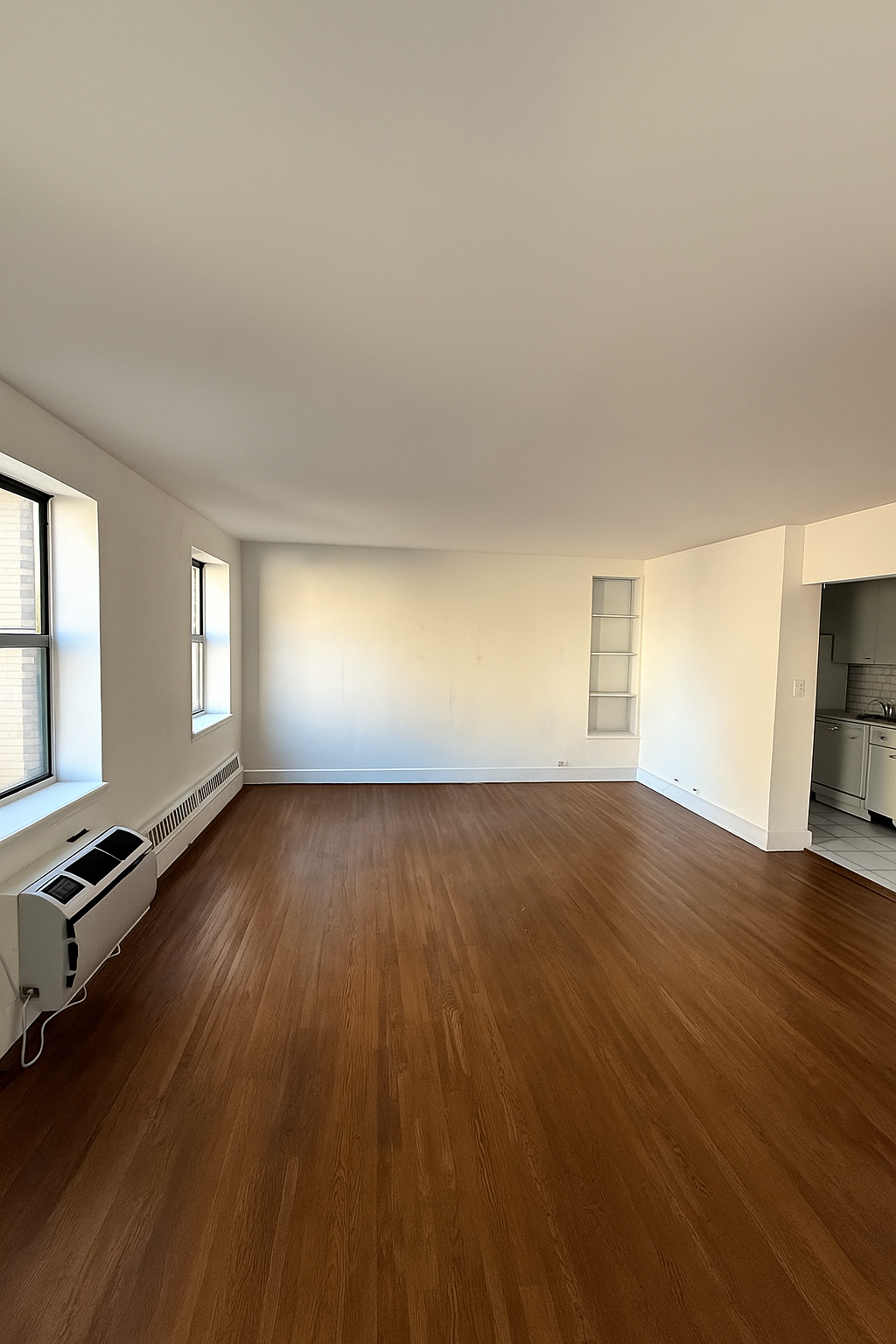 455 Park Avenue South, Unit PH1 Manhattan, NY 10016 - Photo 2 of 17 an empty room with wooden floor and windows