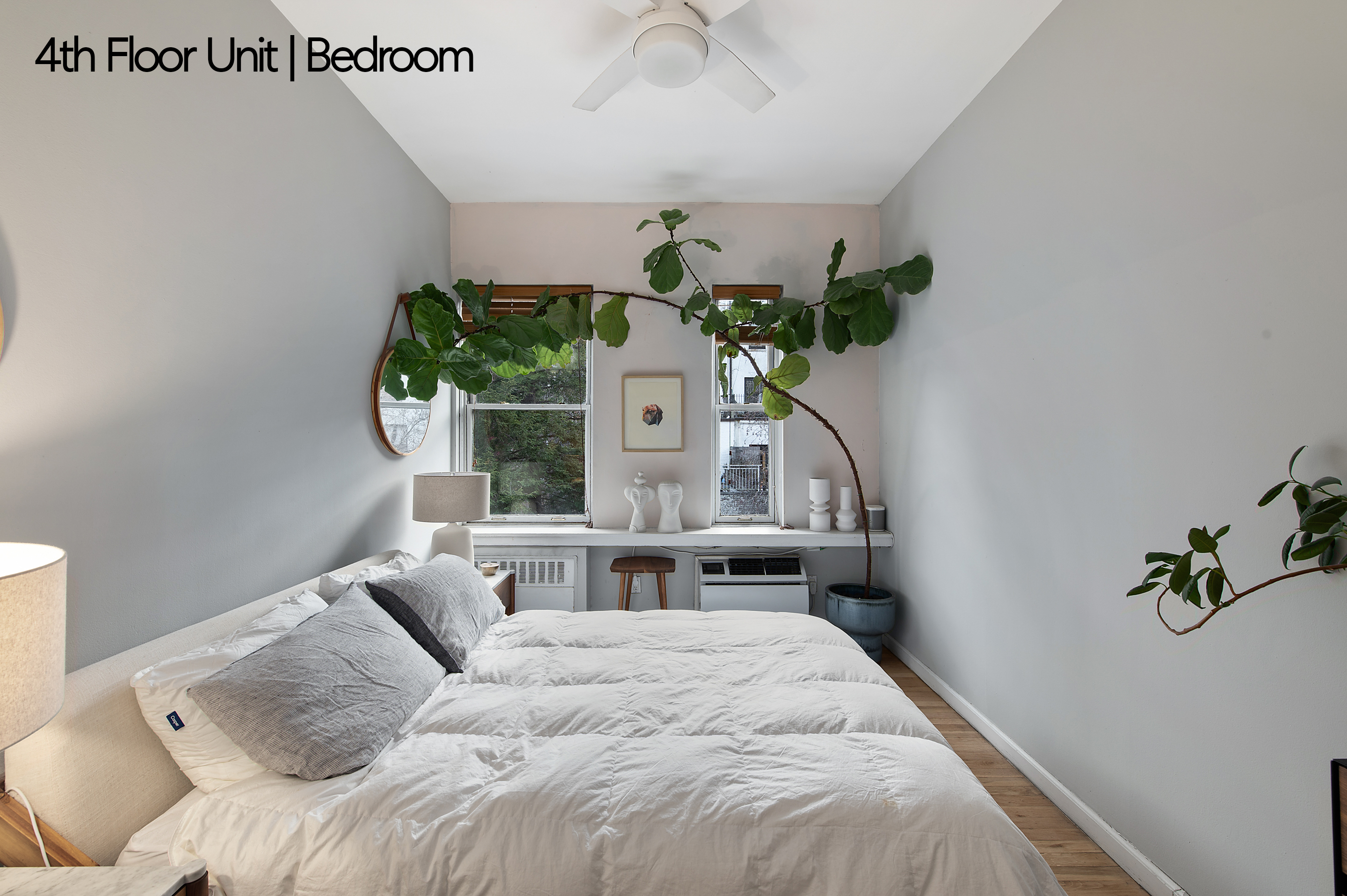 126 West 78th Street Manhattan, NY 10024 - Photo 22 of 39 a bedroom with a bed table and a window