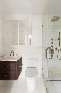 a bathroom with a toilet sink shower and mirror