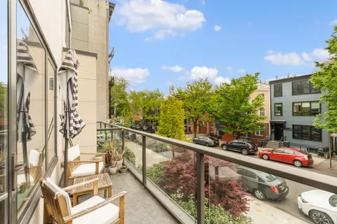 a view of a balcony with two chairs and a table