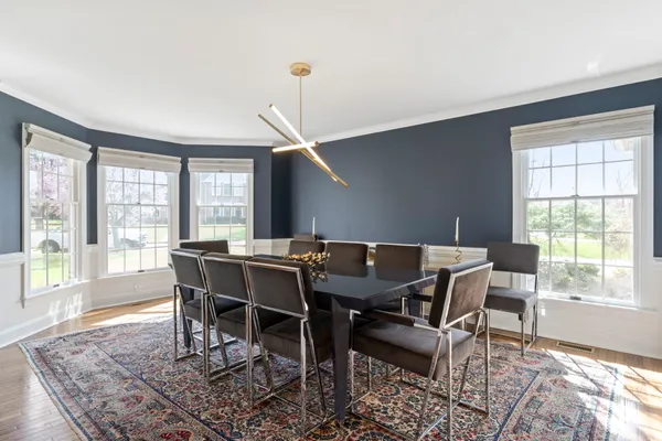a view of a dining room with furniture and chandelier
