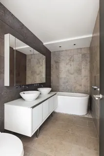 a bathroom with a granite countertop sink and a bathtub