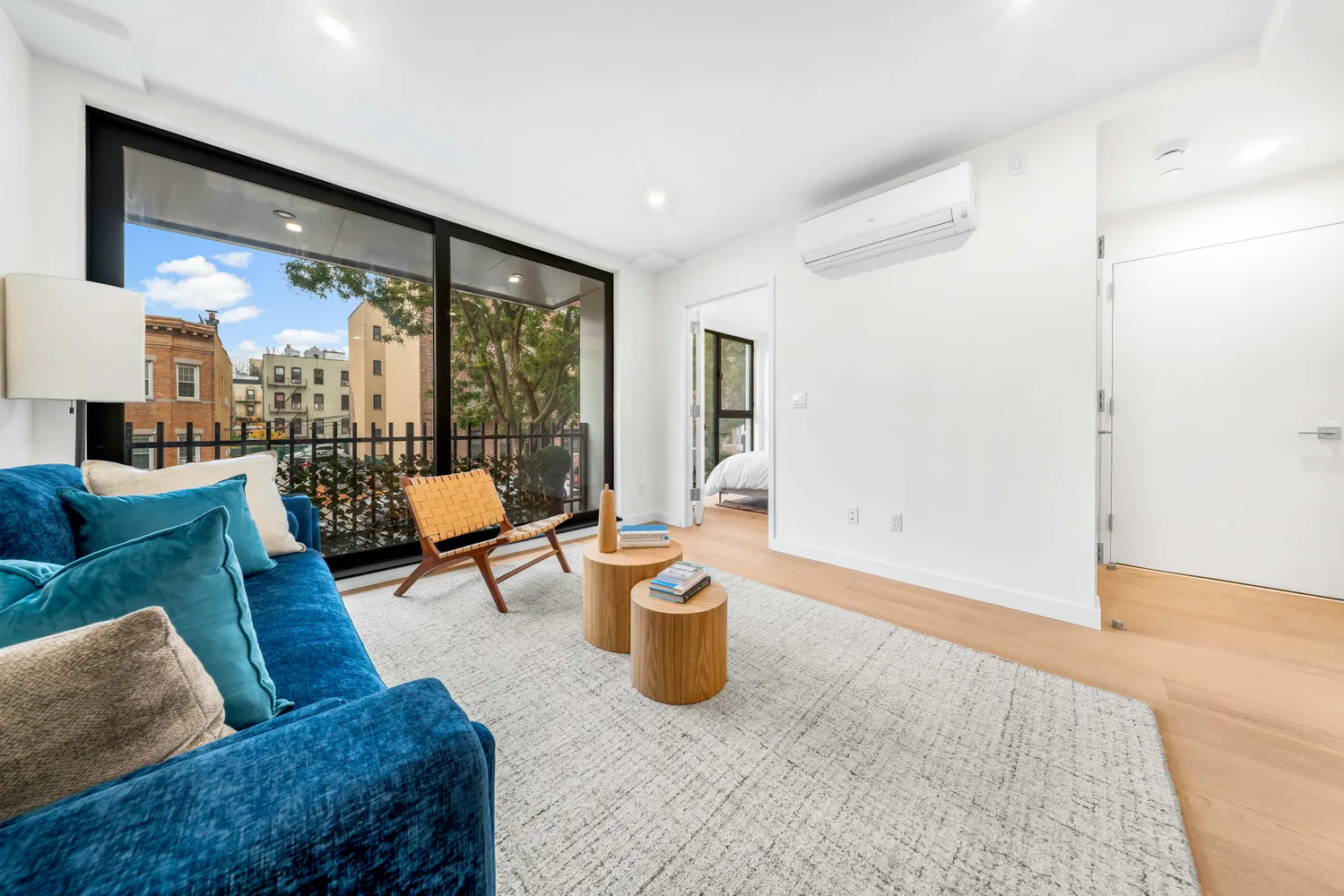 a living room with furniture a rug and a large window