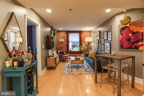 a view of a dining room with furniture a chandelier and wooden floor