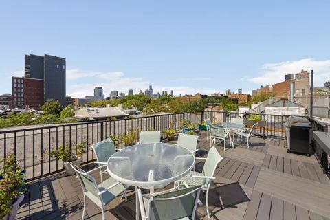 a view of a balcony with table and chairs