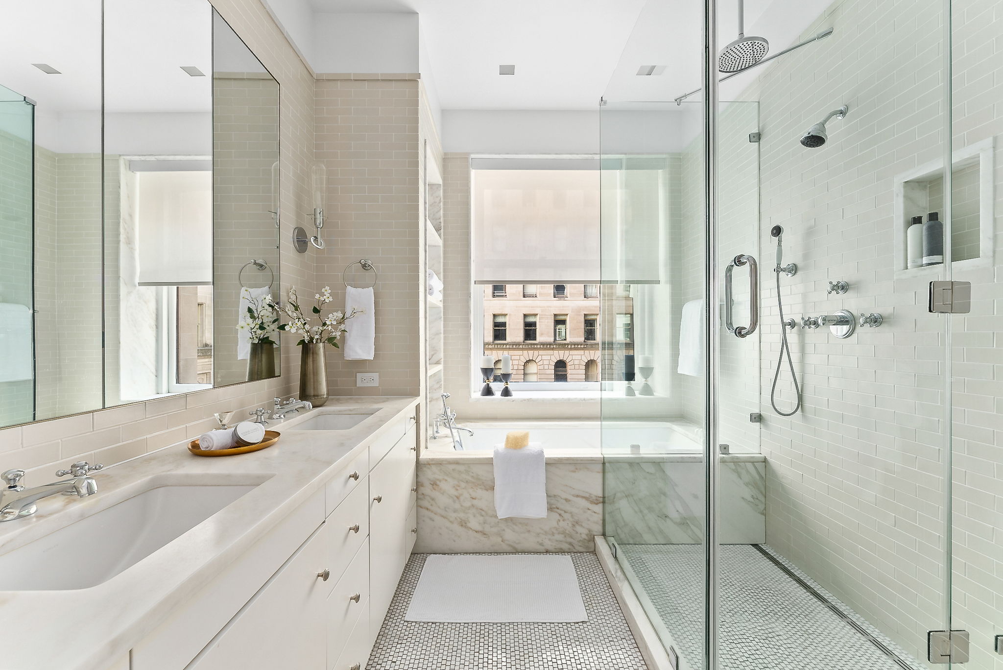 390 West End Avenue, Unit 4J Manhattan, NY 10024 - Photo 7 of 17 a bathroom with a granite countertop shower a sink and a mirror
