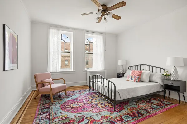 a bedroom with a bed a rug and a window