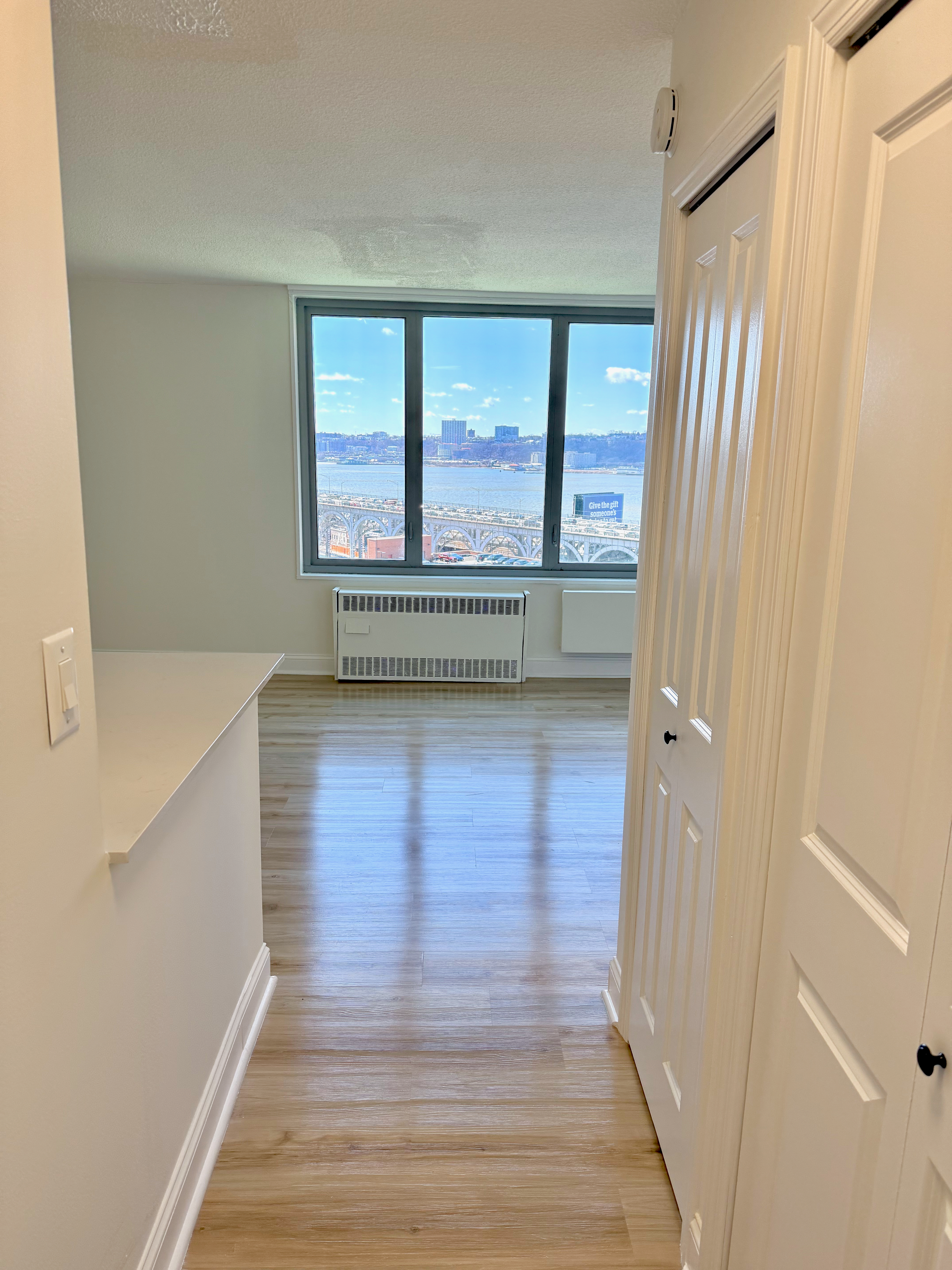 3333 Broadway, Unit D8J Manhattan, NY 10031 - Photo 7 of 22 a view of room with window and wooden floor