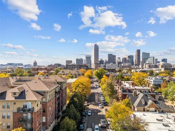 a view of a city with tall buildings and a big yard