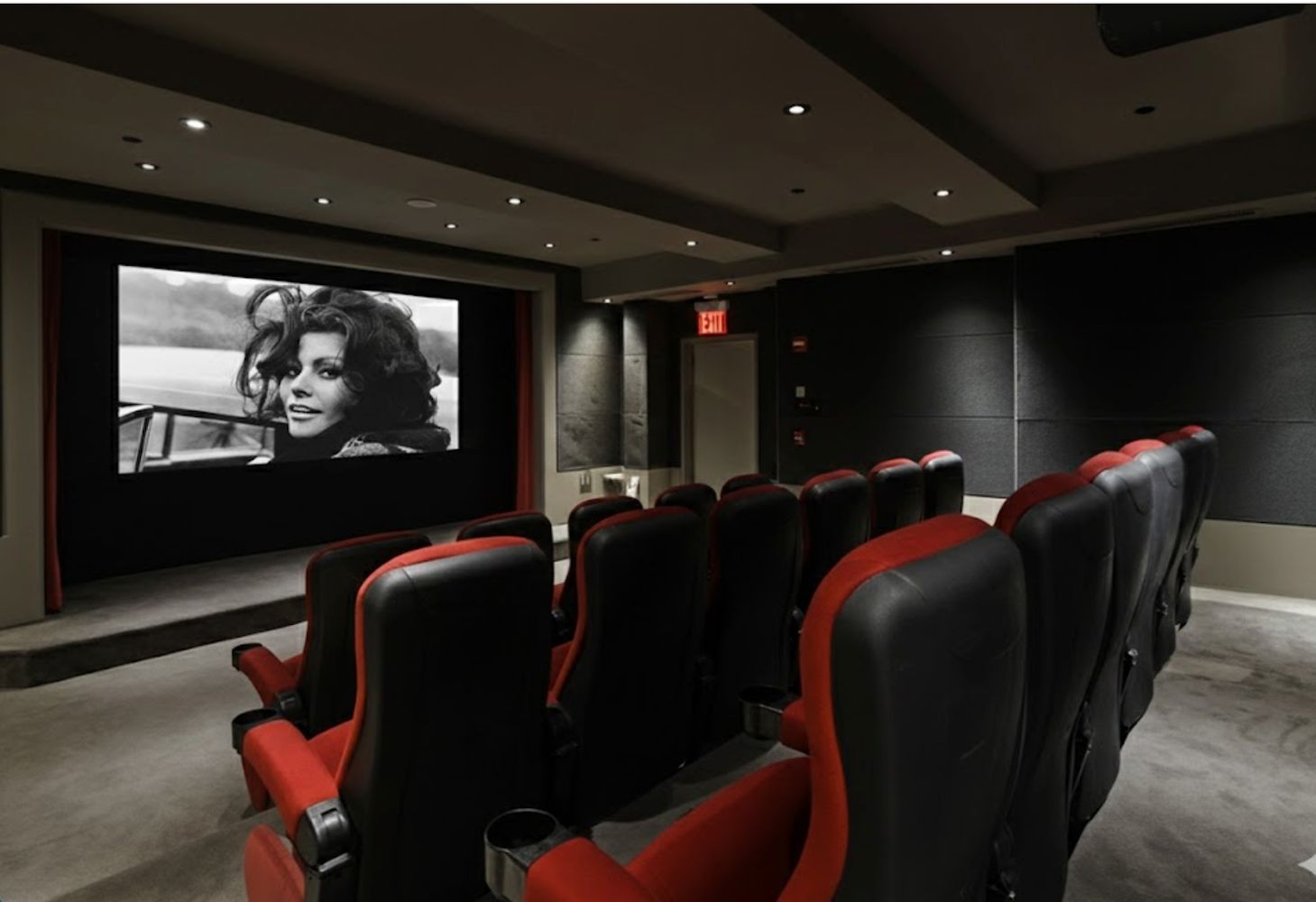 15 Broad Street, Unit 3120 Manhattan, NY 10005 - Photo 12 of 15 a media room with lots of chairs and a projector screen