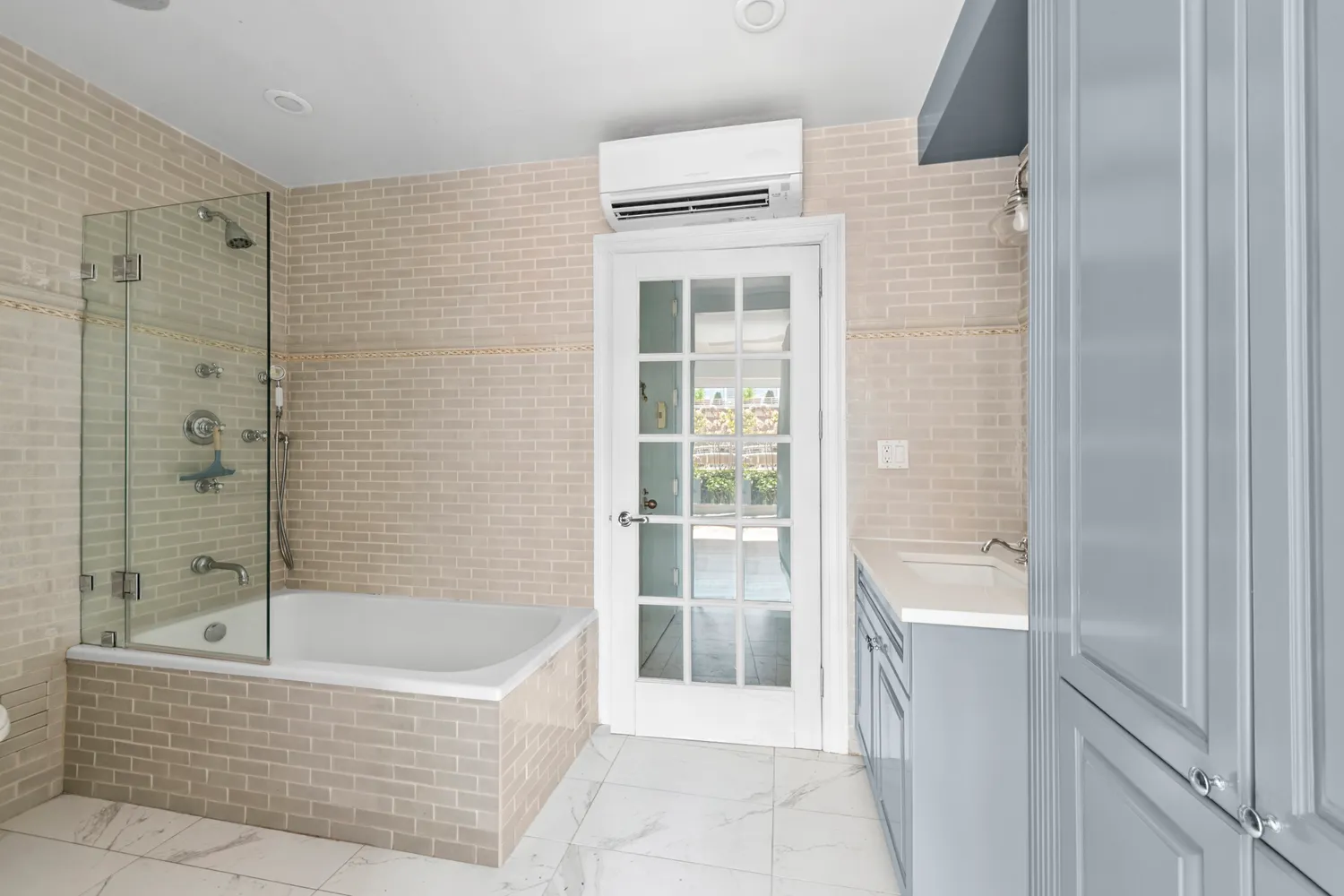 a bathroom with a bathtub and shower