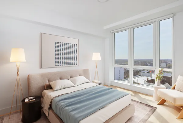 a bedroom with a large bed and a large window