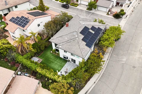 an aerial view of a house with a yard and garden