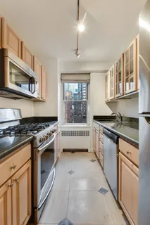a kitchen with stainless steel appliances granite countertop a stove and a sink
