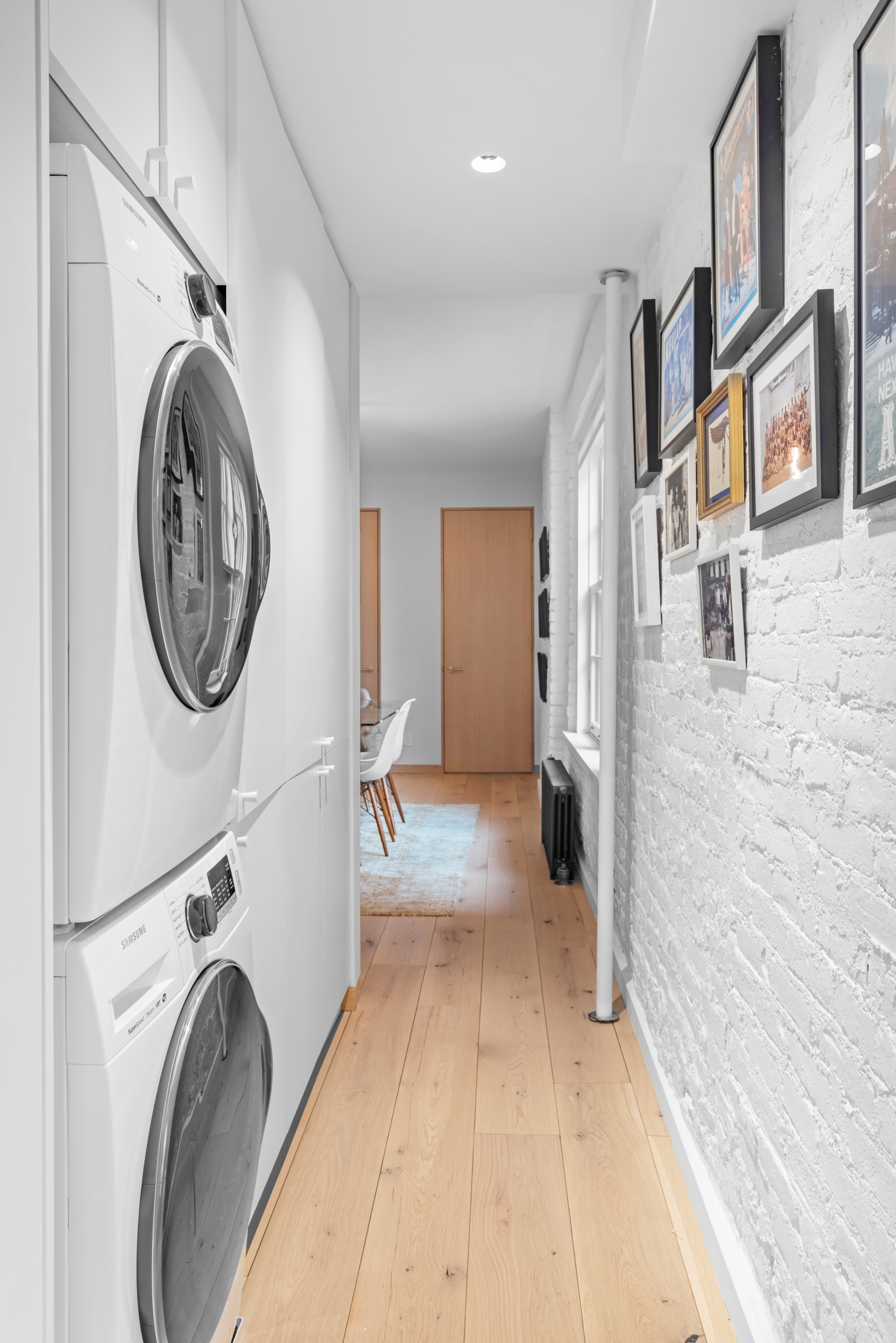 57 Thompson Street, Unit 4E Manhattan, NY 10012 - Photo 15 of 16 a view of a hallway with washer and dryer