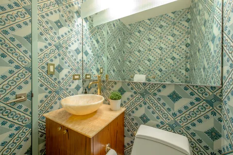 a bathroom with a sink toilet and a mirror