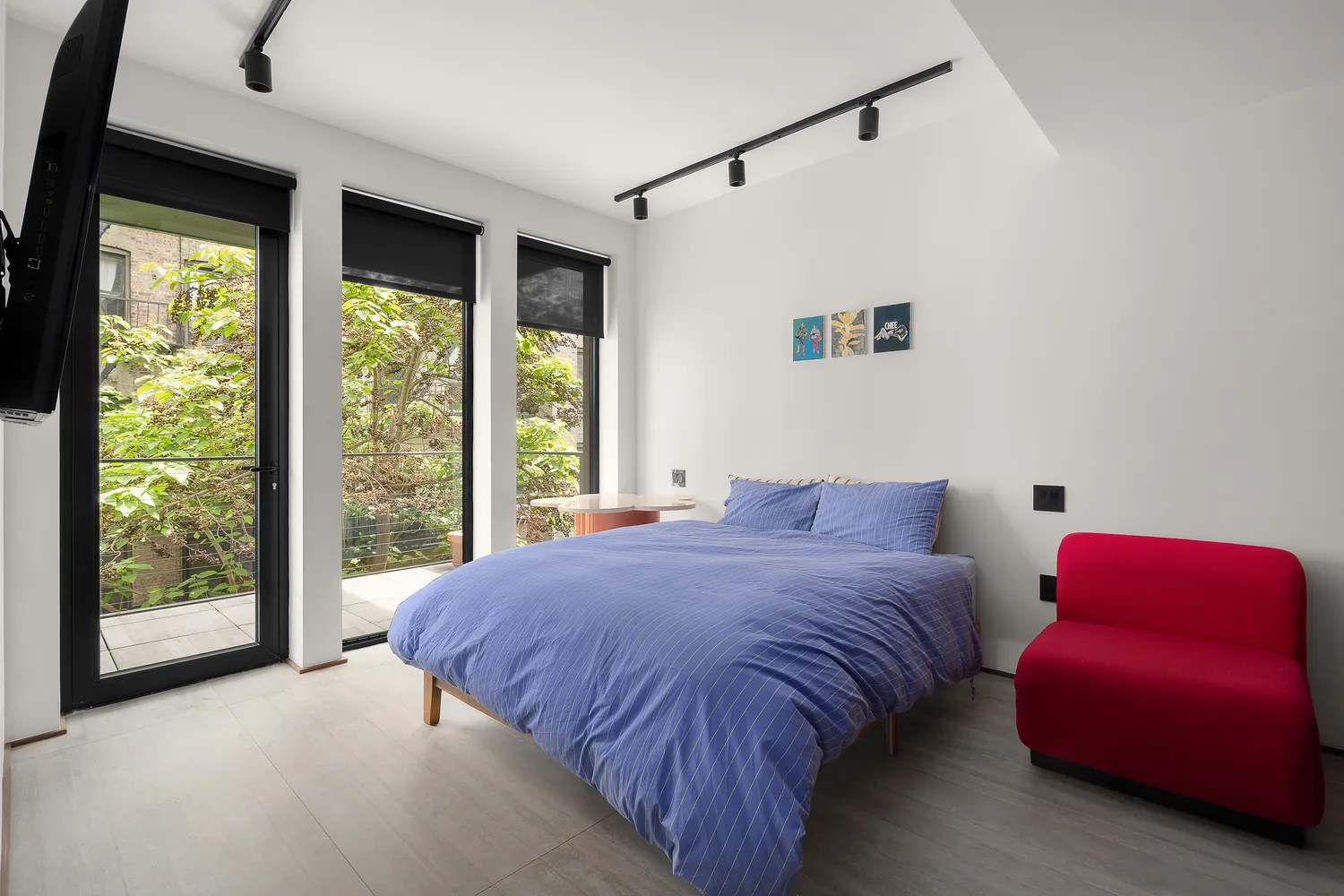 a bed sitting in a bedroom next to a window