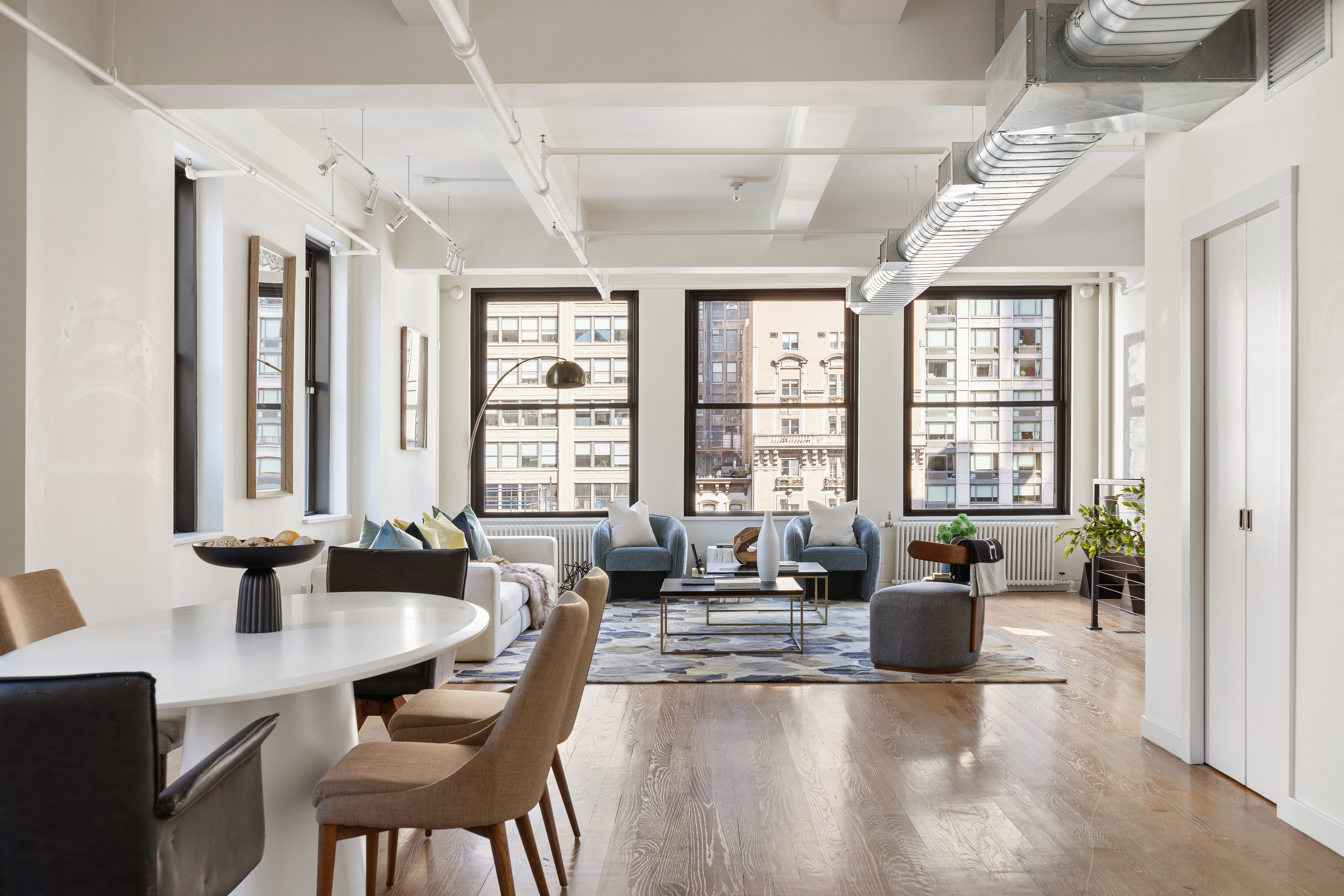 24 West 30th Street, Unit 6 Manhattan, NY 10001 - Photo 2 of 14 a living room with furniture and large windows