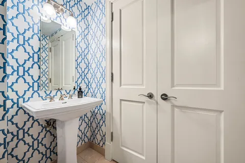 a bathroom with a sink a mirror and a shower