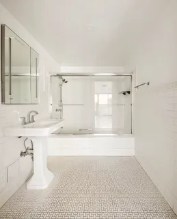 a bathroom with a tub sink and mirror