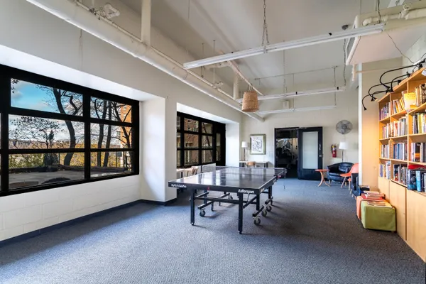 a dining room with furniture and a window