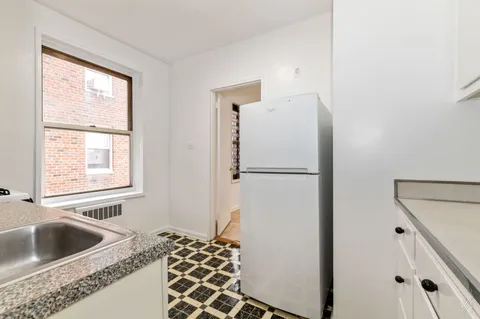 a kitchen with a refrigerator and a sink