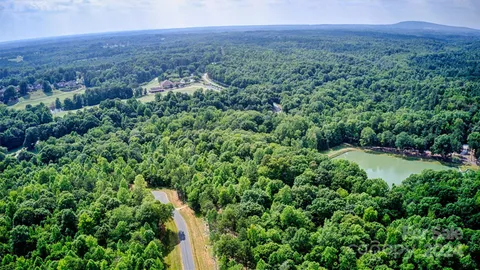 an aerial view of a house with a yard and lake view