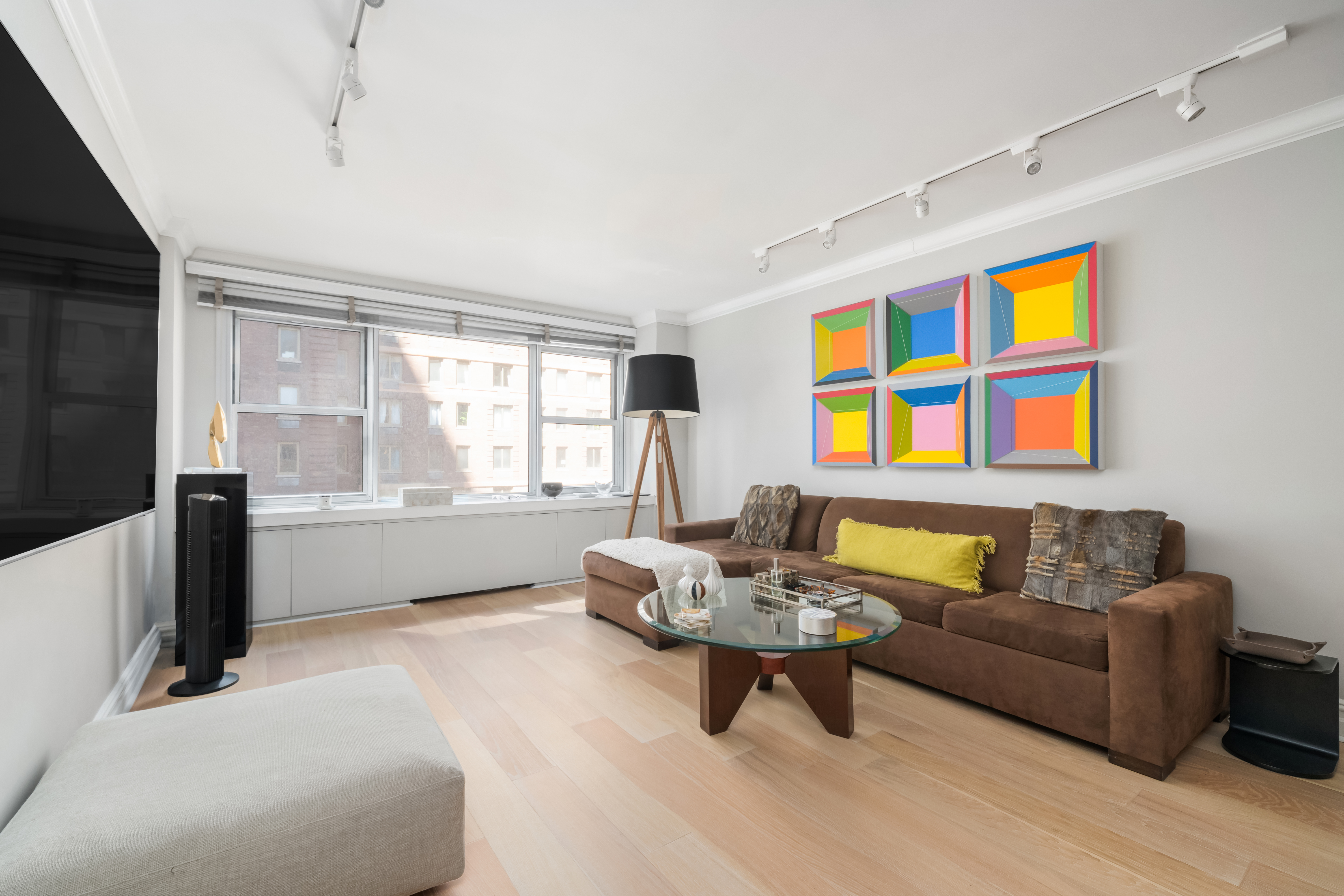 77 West 55th Street, Unit 9F Manhattan, NY 10019 - Photo 3 of 11 a living room with furniture and windows
