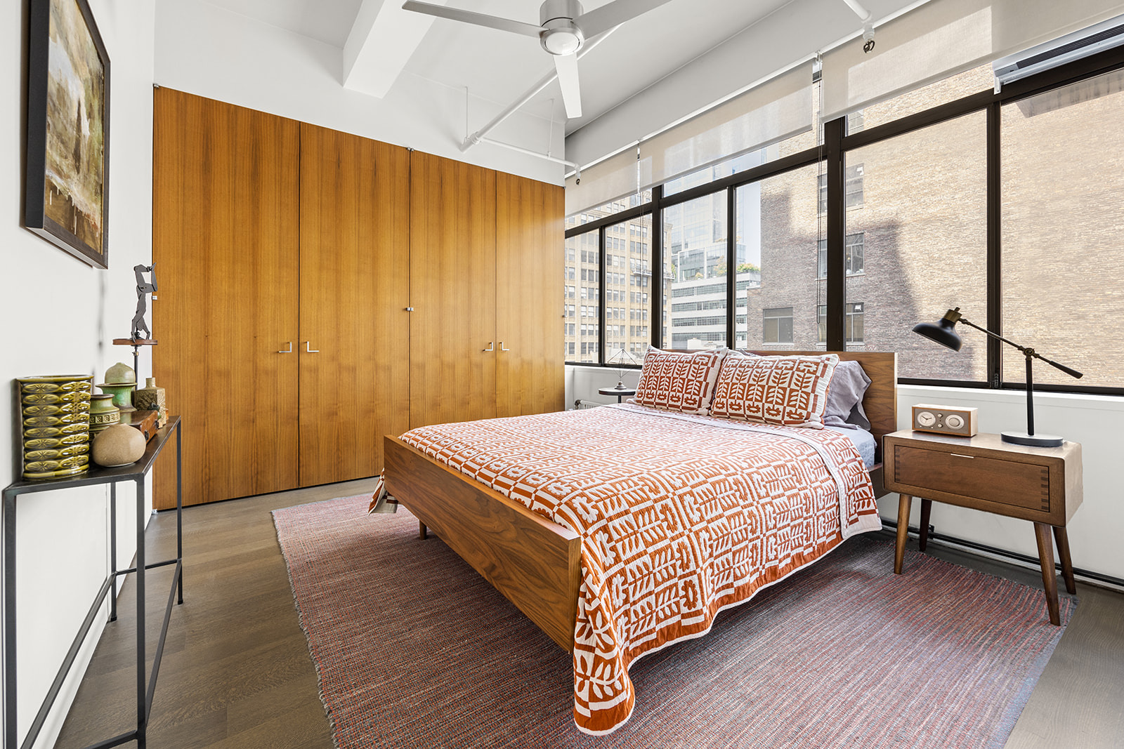 348 West 36th Street, Unit 6N Manhattan, NY 10018 - Photo 5 of 12 a bedroom with a bed and large window with balcony view