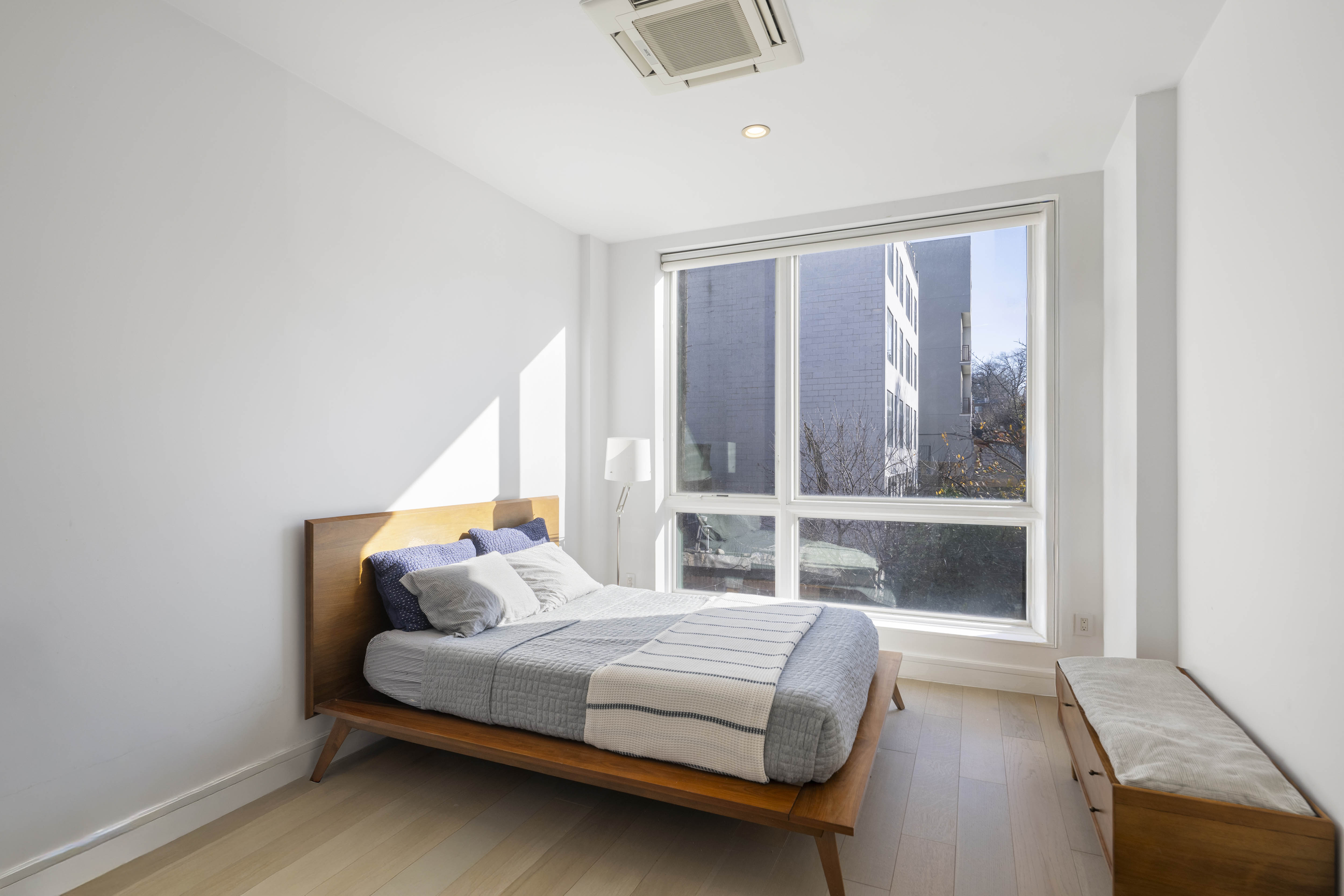 695 6th Avenue, Unit 2P Brooklyn, NY 11215 - Photo 4 of 15 a bedroom with a bed and a large window