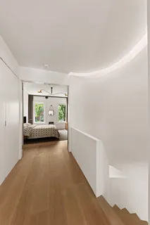 a view of a bedroom with a bed and a window