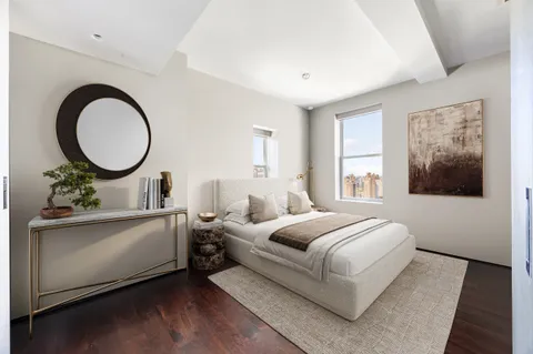 a bedroom with bed and a large window