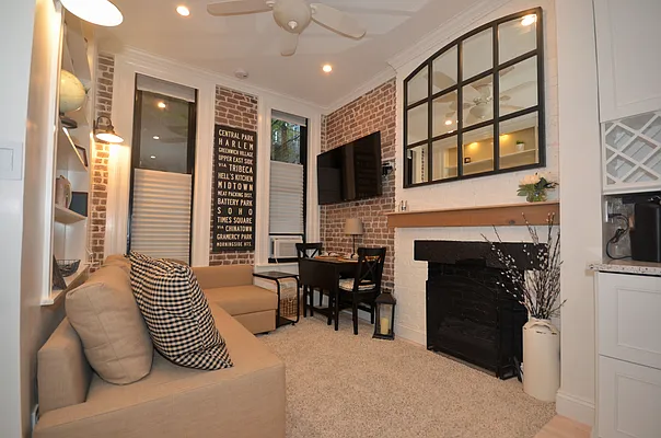 a view of living room with furniture and fireplace