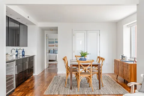 a view of a dining room with furniture and wooden floor