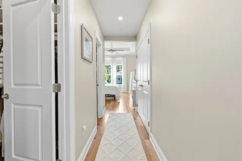 a view of a hallway with a livingroom and a bathroom with a sink