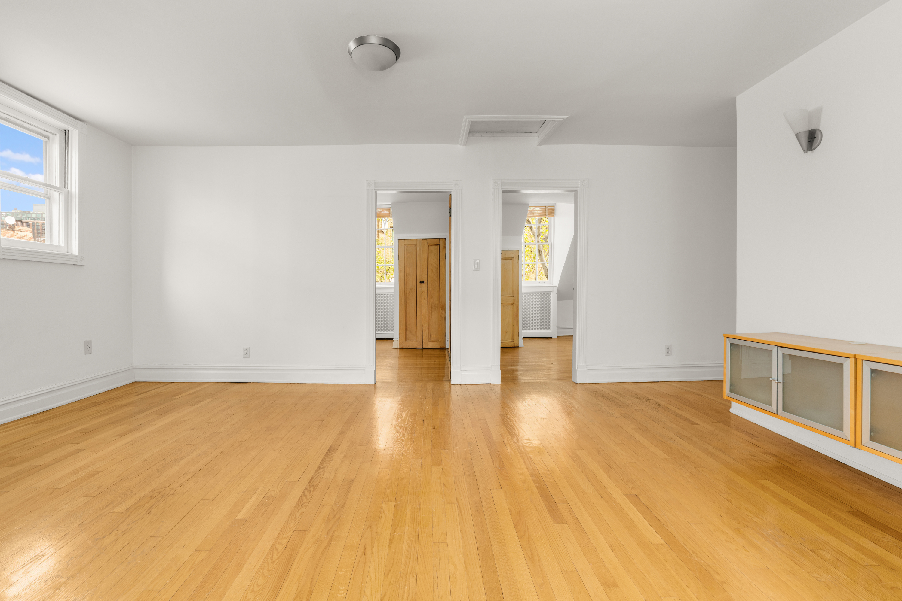 60 Hicks Street Brooklyn, NY 11201 - Photo 12 of 22 a view of an empty room with wooden floor and a window