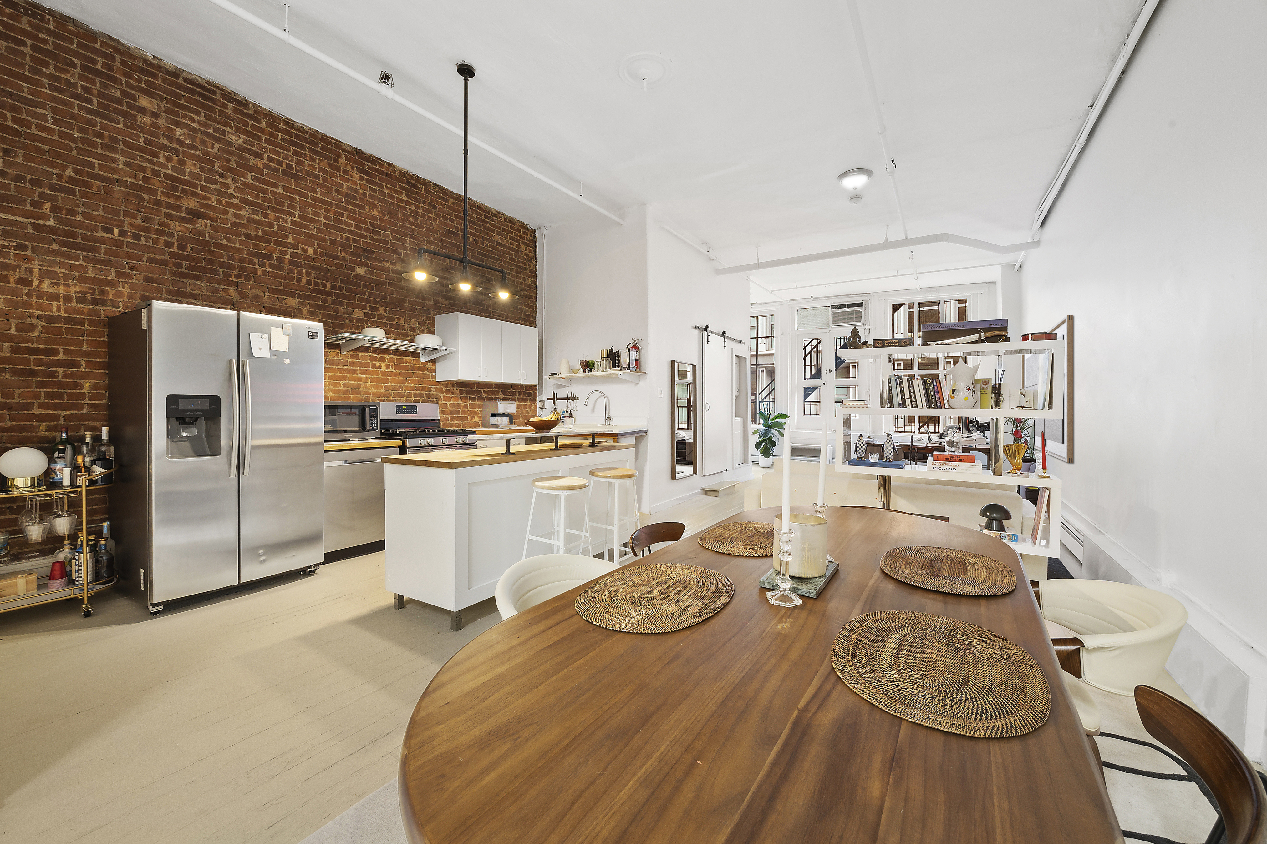 8 Greene Street, Unit 3 Manhattan, NY 10013 - Photo 1 of 7 a kitchen with white cabinets and refrigerator